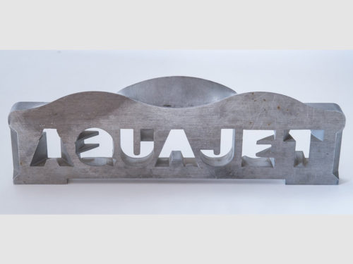 This plate illustrates the abilities of the 5-axis waterjet. The text reads the same from both sides, meaning that each letter transitions to a different letter on the opposite side.