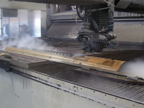 Cutting windows into a rolled steel plate using our 5-axis waterjet. Watch the Video