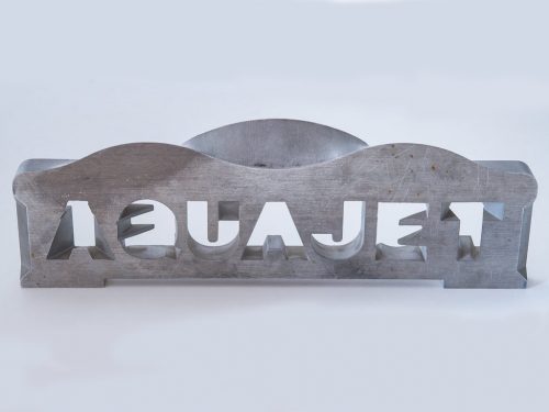 This plate illustrates the abilities of the 5-axis waterjet. The text reads the same from both sides, meaning that each letter transitions to a different letter on the opposite side.